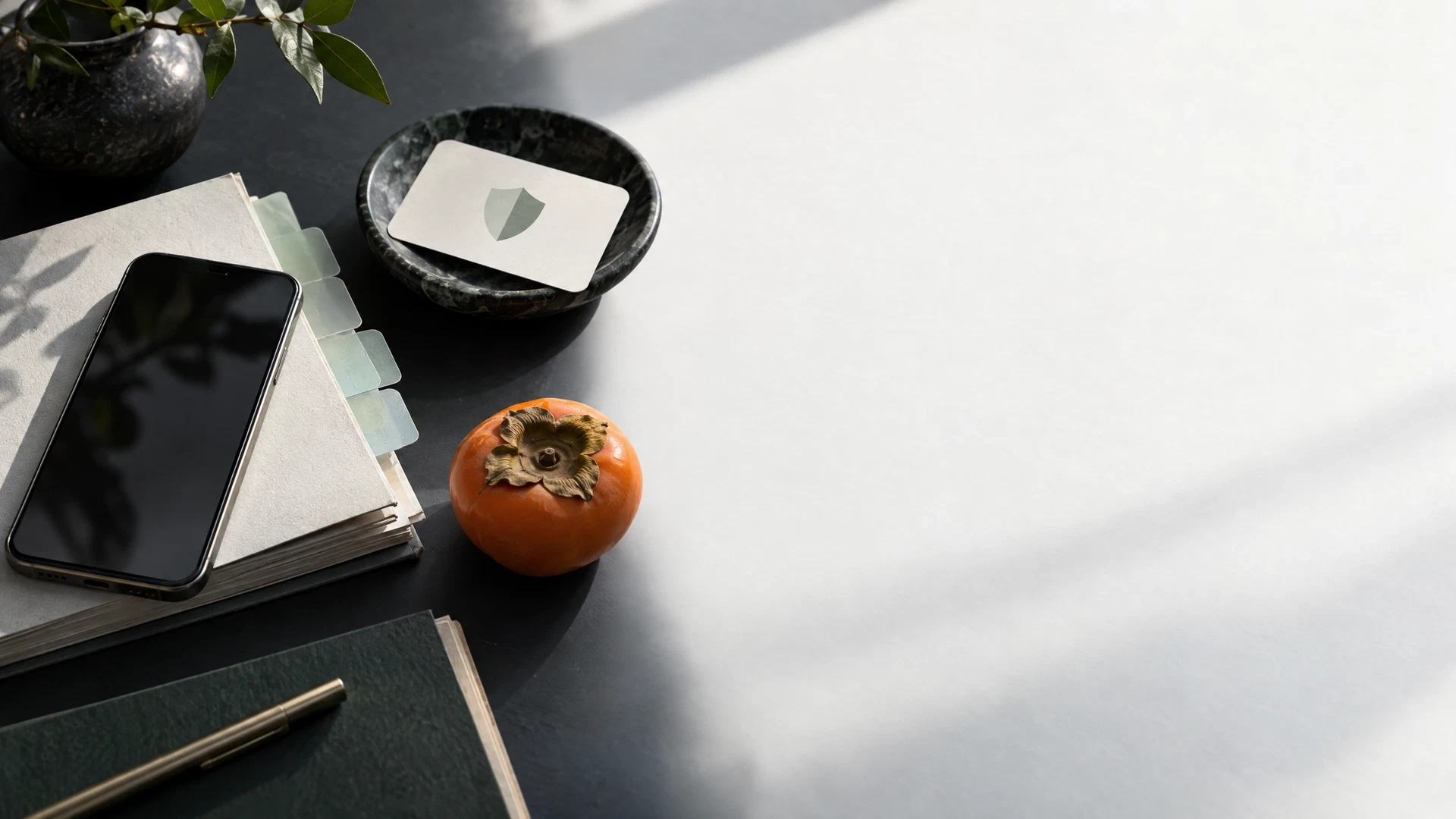 Generic phone with blank permission card and sea glass tabs on midnight desk